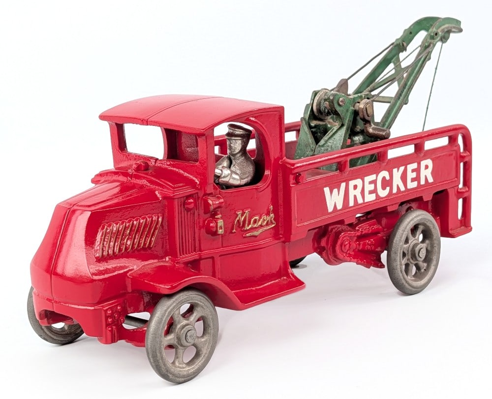 Arcade Cast Iron Mack Wrecker Tow Truck: Arcade cast iron Mack wrecker tow truck. The truck is restored, but the Weaver tow boom is original. The truck is painted in red overall with gold "Mack" lettering embossed on the doors and "Wrecker" 
