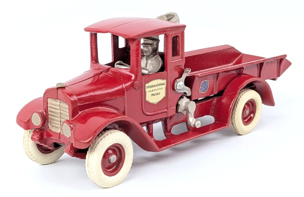 Arcade Cast Iron International Harvester Red Baby Dump Truck: Arcade cast iron International Harvester Red Baby dump truck. The truck has a nice restoration with replacement decals and parts. It looks like the driver side rear fender was repaired during the rest