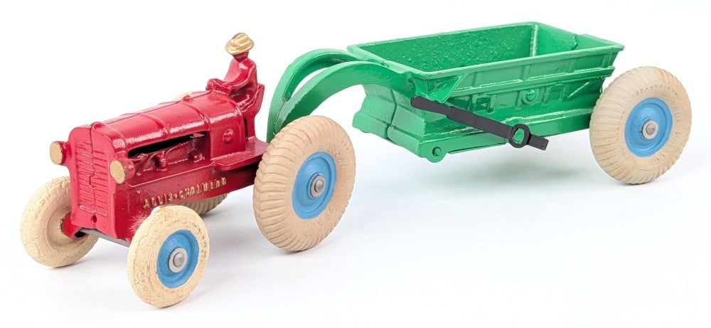Arcade Allis-Chalmers Tractor with Bottom Dump Trailer: Arcade cast iron Allis-Chalmers tractor with bottom dump trailer. A nice restoration. Some of the wheels showing wear from age. Measures approximately 12" long.