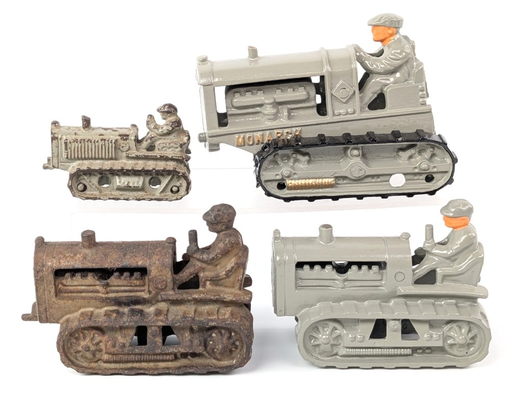 (4) Hubley Cast Iron Monarch Crawler Tractor: Hubley cast iron crawler tractors. The largest is marked "Monarch" and the others are unmarked. All tractors are marked "Hubley" on the underside. The Monarch crawler has been restored as well as one 