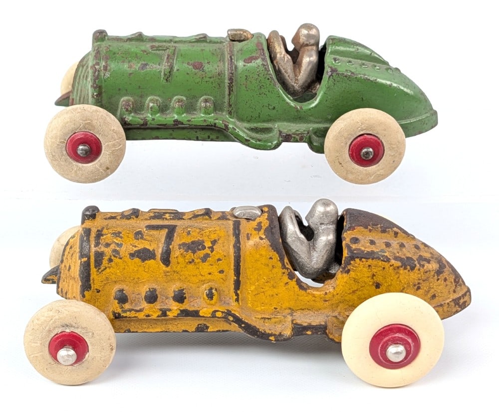 (2) Hubley Cast Iron #7 Race Cars: (2) Hubley cast iron #7 race cars. The yellow car has had the axles replaced and wheels. It will need some work. The green car is good overall with some paint loss and wear from age. Each measures app