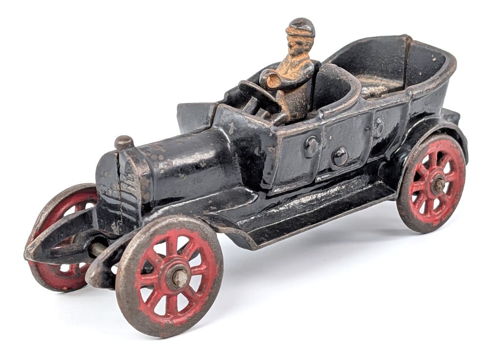 Cast Iron Touring Car: Cast iron touring car sedan. The driver isn't original to this vehicle and it is missing the passenger. Shows paint loss and wear from age. Measures approximately 7" long.