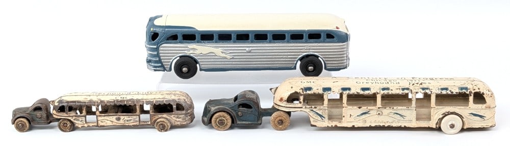 Arcade Cast Iron Greyhound Lines Buses: Includes two Arcade Greyhound Lines Century of Progress buses and one Greyhound Lines bus. The larger trailer has one replacement wheel and is missing the other wheel. The one bus is in restored condi