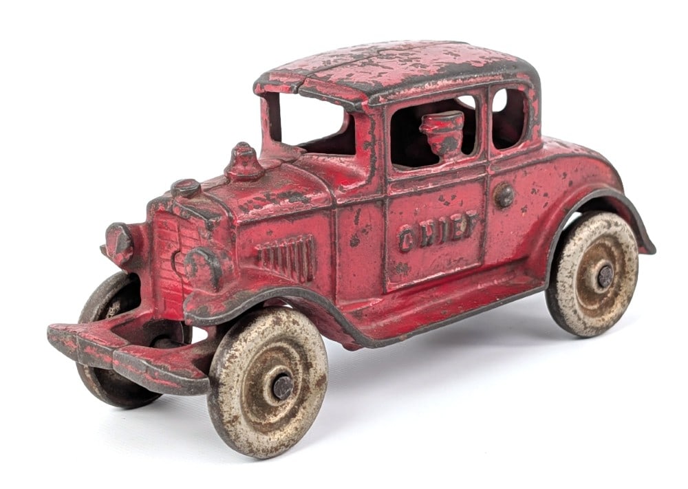 Kenton Cast Iron Fire Chief Coupe Car: Kenton cast iron Fire Chief coupe car. Nickeled wheel version. Original with paint loss and wear from play and age. No visible cracks or breaks. Measures approximately 5-1/2" long.