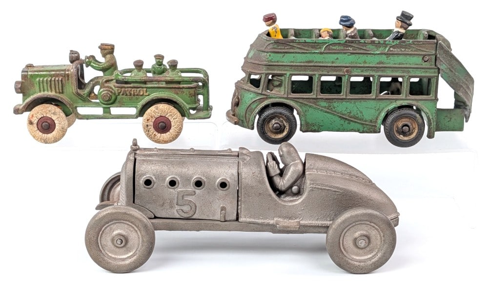 Hubley Racer, Patrol Truck, and Arcade Double Decker Bus: Cast iron Hubley #5 boattail racer, Hubley or Kenton Patrol truck, and Arcade double decker bus. All have some issues. The boattail racer has a repair on the front axle housing and was stripped. The P