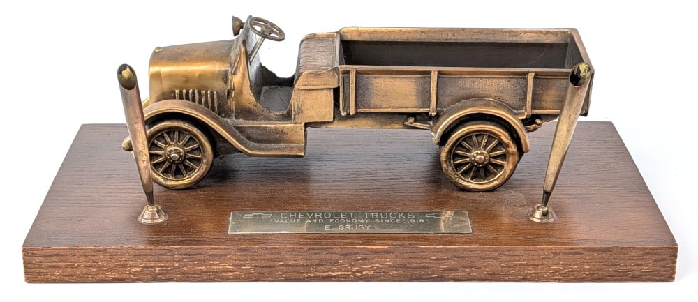 Vintage Chevrolet Trucks Desktop Pen Holder: Vintage Chevrolet Trucks desktop pen holder. Brass tag reads "Chevrolet Trucks Value and Economy Since 1918 E. Grusy". The truck is metal on a wooden base with two pen holders. Base measures approxima
