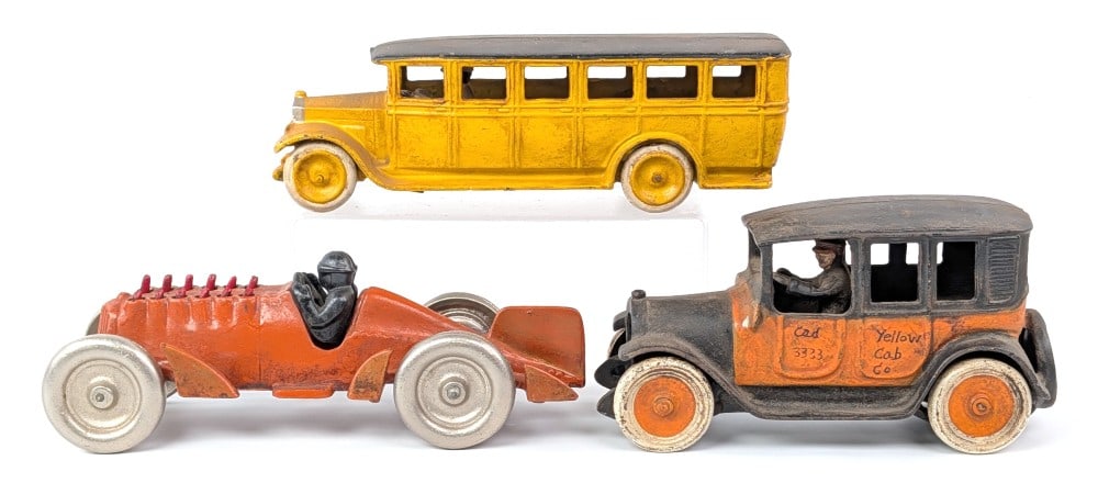 Reproduction Yellow Cab Taxi, Hubley Golden Arrow, and Seto Bus: (3) Reproduction cast iron toys. Includes Arcade Yellow Cab Co. taxi, Hubley Golden Arrow racer, and Skoglund & Olsen Seto Fageol bus. All are nice reproductions of the original toys. The bus measures