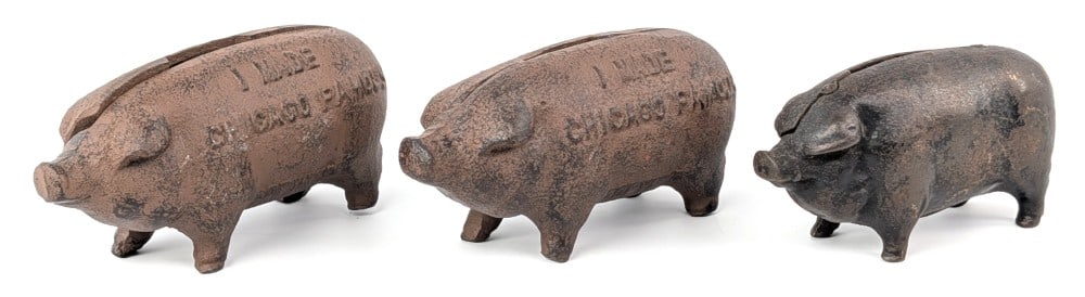 (3) Cast Iron Pig Still Banks: (3) Cast iron pig still banks. Includes (2) marked "I Made Chicago Famous". All showing loss and wear. Largest measures 4-1/2" long.