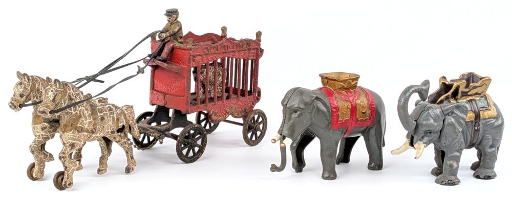 Cast Iron Overland Circus Wagon and Elephant Banks: Kenton cast iron Overland circus wagon and semi mechanical elephant banks. The wagon and horse team show heavy paint crackling and wear. The elephants are newer production banks. The horse and wagon m