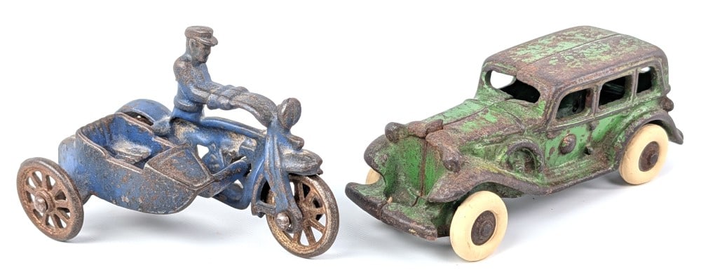 Hubley Cop Motorcycle with Sidecar and AC Williams Sedan: Hubley cast iron Cop motorcycle with sidecar and AC Williams green sedan. The motorcycle is missing the passenger. Tires are older replacements on the sedan. Both show paint loss and wear from age. Th