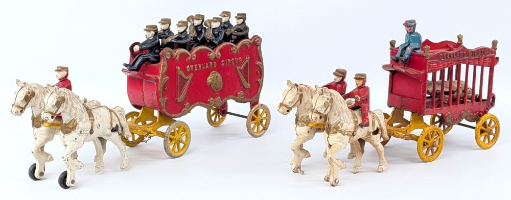 Cast Iron Overland Circus Band Wagon and Animal Wagon: Kenton cast iron Overland Circus band wagon and animal wagon. Missing the rear gate on the animal wagon. Measure approximately 16" long.