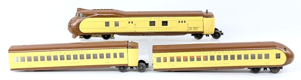 Lionel Union Pacific Streamliner Passenger Set: Lionel O Gauge Union Pacific streamliner passenger set. Set includes 752e power car, 753 / 754 passenger cars, and two vestibules. Set has some repaint, scuff marks, and cracked windows.?