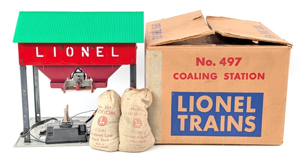Lionel No. 497 Coaling Station in Box: Lionel O Gauge No. 497 coaling station in the original box. Good condition and comes with two coal bags. Box shows some creasing and light wear from handling / storage.?