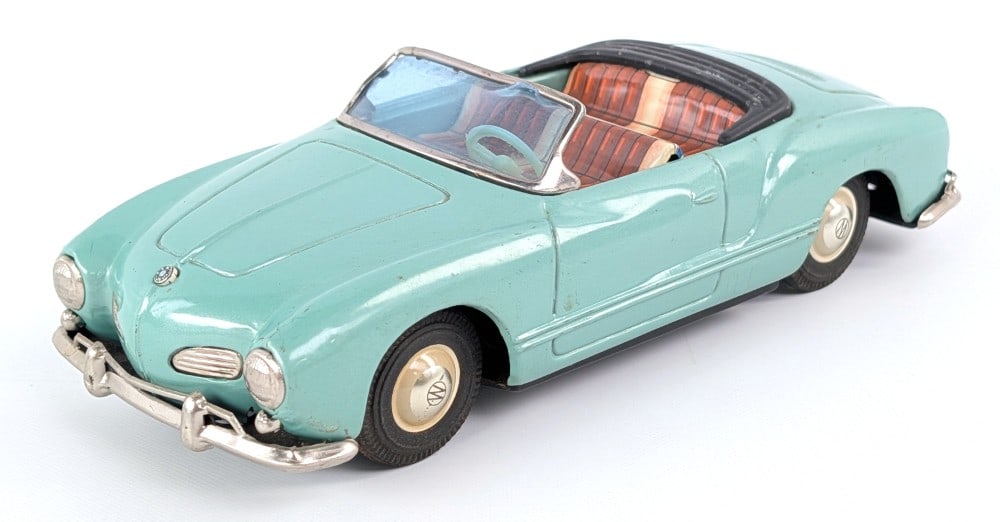 Bandai Japan Tin Friction Karmann Ghia Car: Bandai Japan tin friction Karmann Ghia car. The friction mech is sticky so not currently working. The car shows some light wear from age. Measures approximately 7-1/2" long.