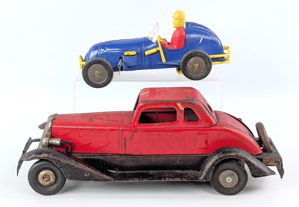 Hoge Fire Chief Car and Plastic Midget Racer Windup: Vintage Hoge Fire Chief windup car with electric headlights and Great Britain plastic windup midget racer. Both showing scratches, paint loss, and wear from play and age.? Largest measures