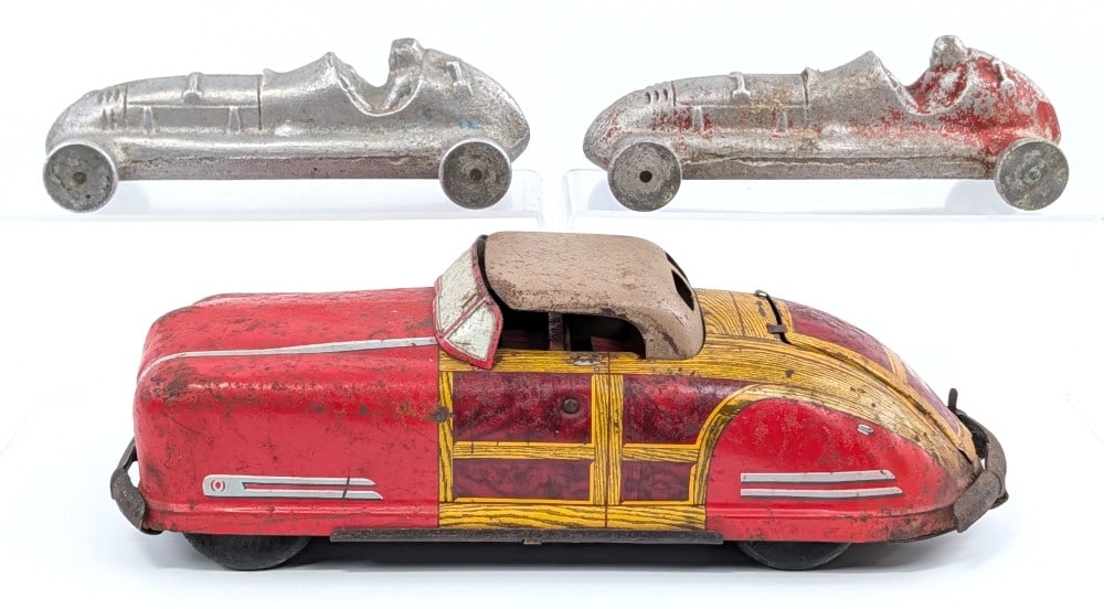Wyandotte Toys Woody Station Wagon Convertible and (2) Racers: Wyandotte Toys Woody Station Wagon convertible and (2) cast aluminum racers. All showing paint loss and wear from age and play. Largest measures 12-1/2" long.