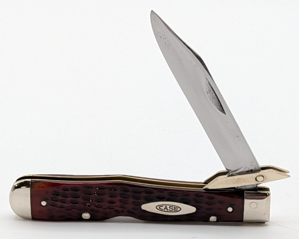 1965-69 Case XX Red Bone Cheetah 6111 1/2: Knife is in good cleaned condition with material loss and scratches on the polished blade, scuffs and dings on the polished bolsters, and a repaired chip on the front handle scale upper bottom pin. Ov