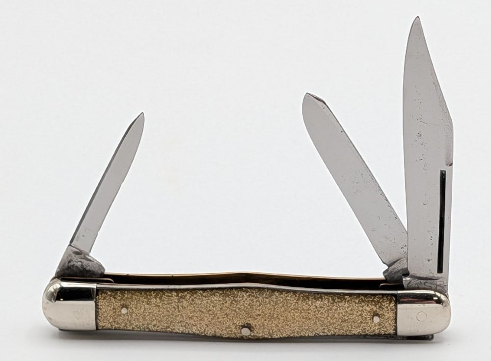 1920-40 Case Tested XX Gold Glitter Celluloid Small Stockman: Knife is in good cleaned condition with light scratches and pitting on the blades, light scuffs on the bolsters, and nice handle scales. Overall measures 3-1/4in when closed.