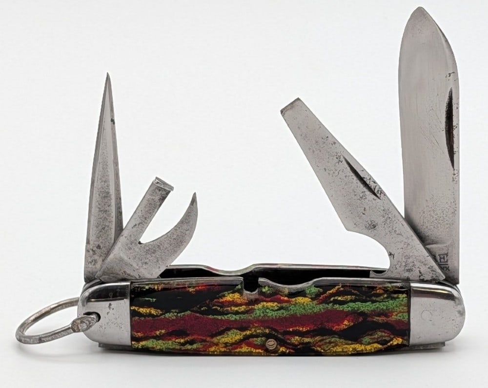 1920-40 Case Tested XX Rehandled Christmas Tree Celluloid Scout Knife: Knife is in fair condition with scratches and tarnishing on the blades, dings and tarnishing on the bolsters, and rehandled handle scales. Overall measures 3-3/4in when closed.
