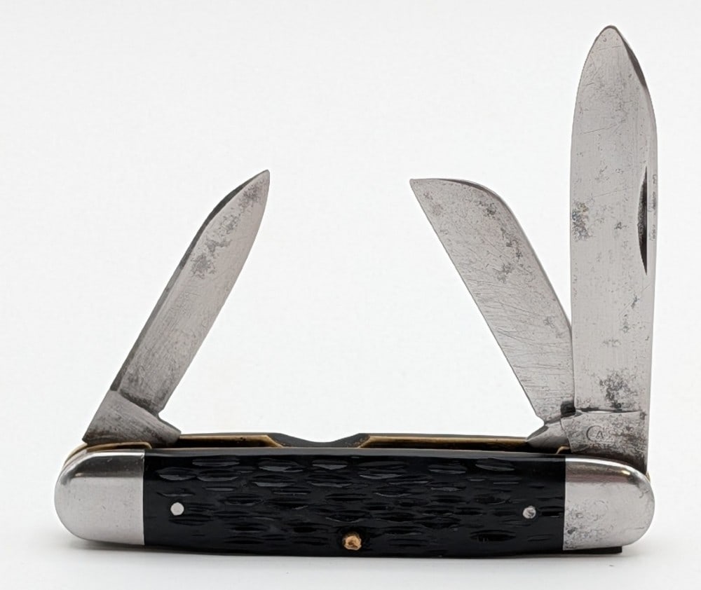 WWII Era Case Tested XX Rough Black Even End Jack Knife: Features WWII era identifiers like the iron bolsters, no shield, and the rough black handle scales. Knife is in good used condition with scratches and tarnishing on the blades, some tarnishing on the 