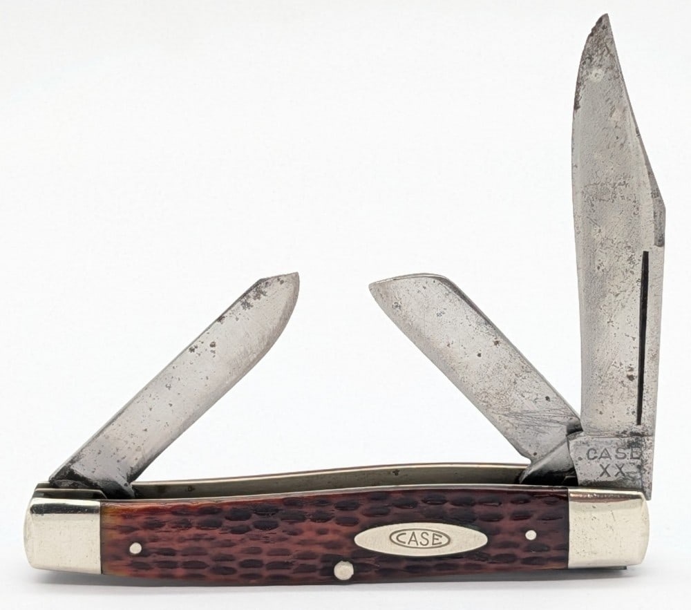 1940-64 Case XX Red Bone Long Pull Stockman 6375: Knife is in fair used condition with heavy scratches and some pitting on the blades, scratches and dings on the bolsters, and a large crack on the back handle scale. Overall measures 4-1/4in when clos