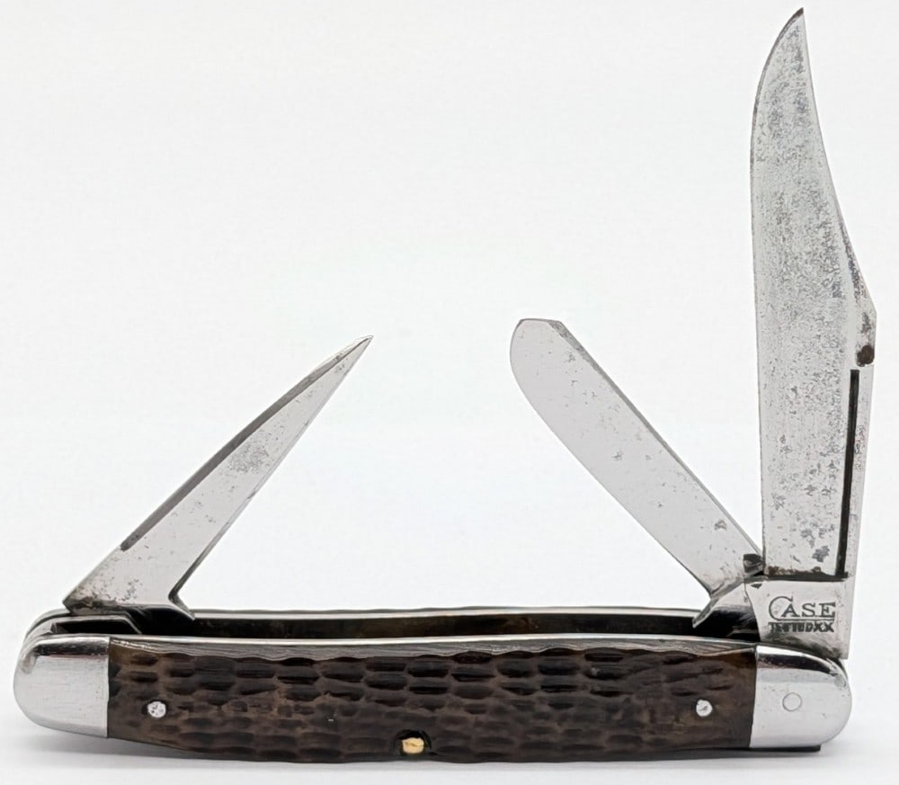 1920-40 Case Tested XX Jigged Bone Long Pull Punch Blade Stockman: Knife is in fair cleaned condition with light scratches and tarnishing on the blades, light scuffs on the polished bolsters, and the front handle scale has a crack and chip missing on the bottom pin. 