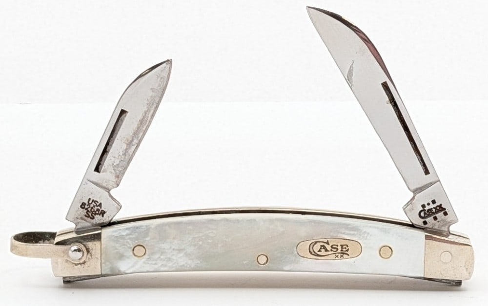 2004 Case XX Mother of Pearl Small Congress Knife 8268R: Knife is in fair condition with scratches on the blades, and scuffs and tarnishing on the bolsters. Overall measures 3in when closed.