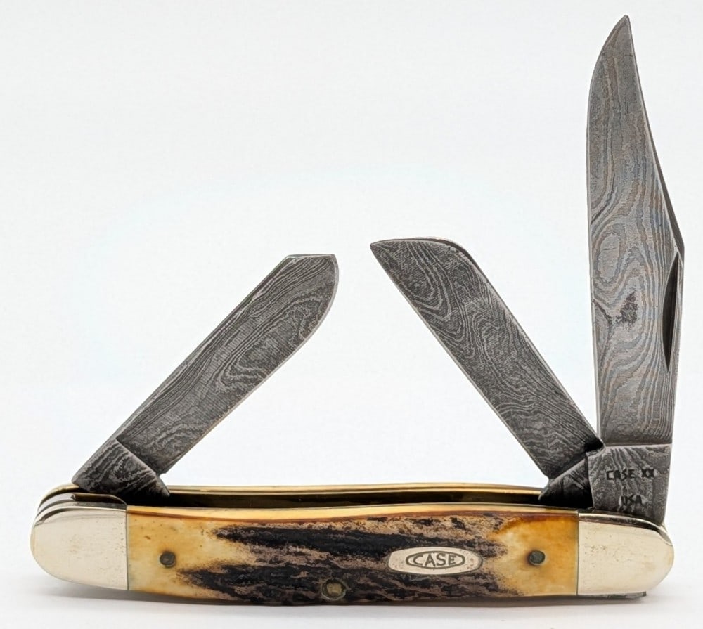 1989 Case XX Stag Damascus Stockman 5347: Knife is in very nice condition with a pit spot on the main blade, and light scuffs on the bolsters from handling. Overall measures 3-7/8in when closed.