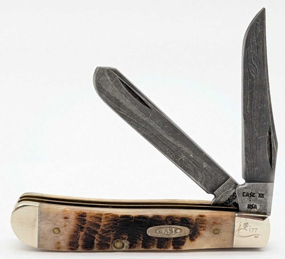 Ltd 1989 Case XX Rogers Bone Damascus Mini Trapper ROG6207: Knife is numbered 177, and is in nice condition with some scuffs and tarnishing on the bolsters from handling. Overall measures 3-1/2in when closed.