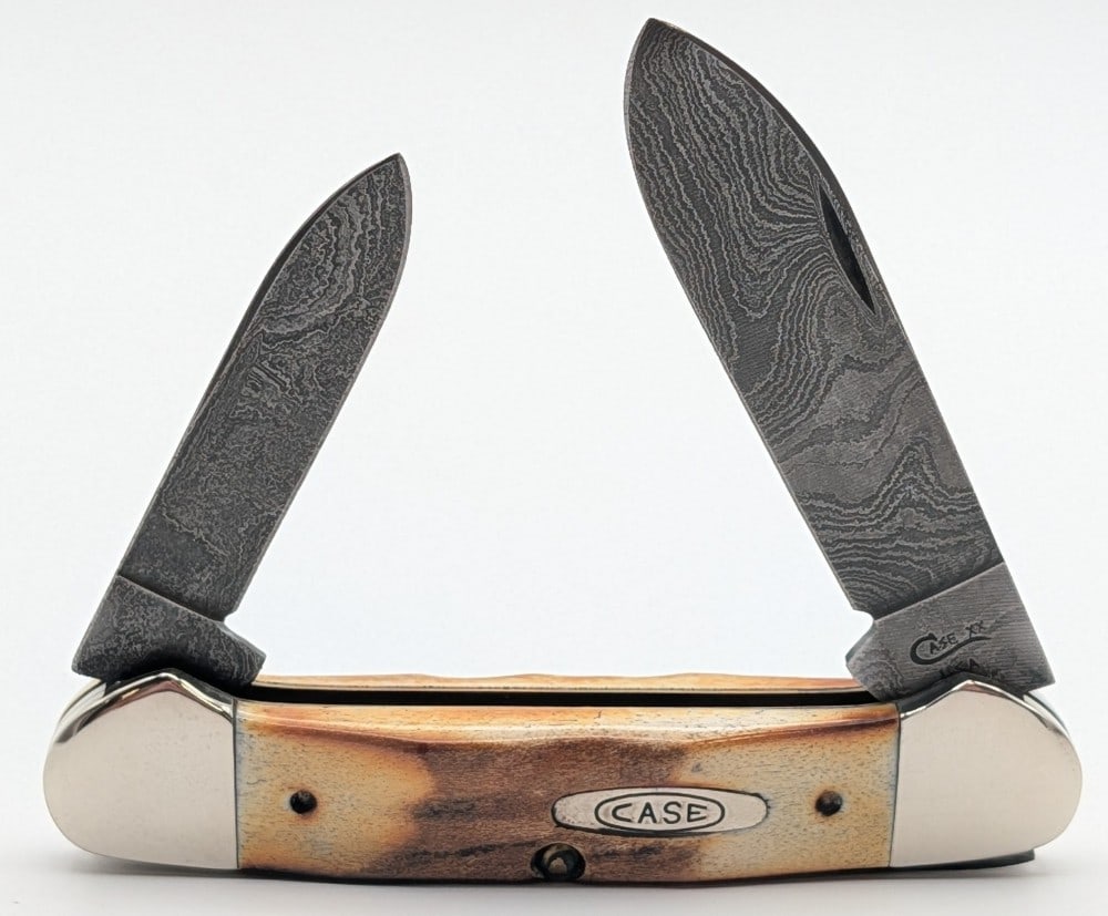 1995 Case XX Stag Damascus Canoe Knife 52131: Knife is in very nice condition with light scuffs on the bolsters from handling. Overall measures 3-5/8in when closed.