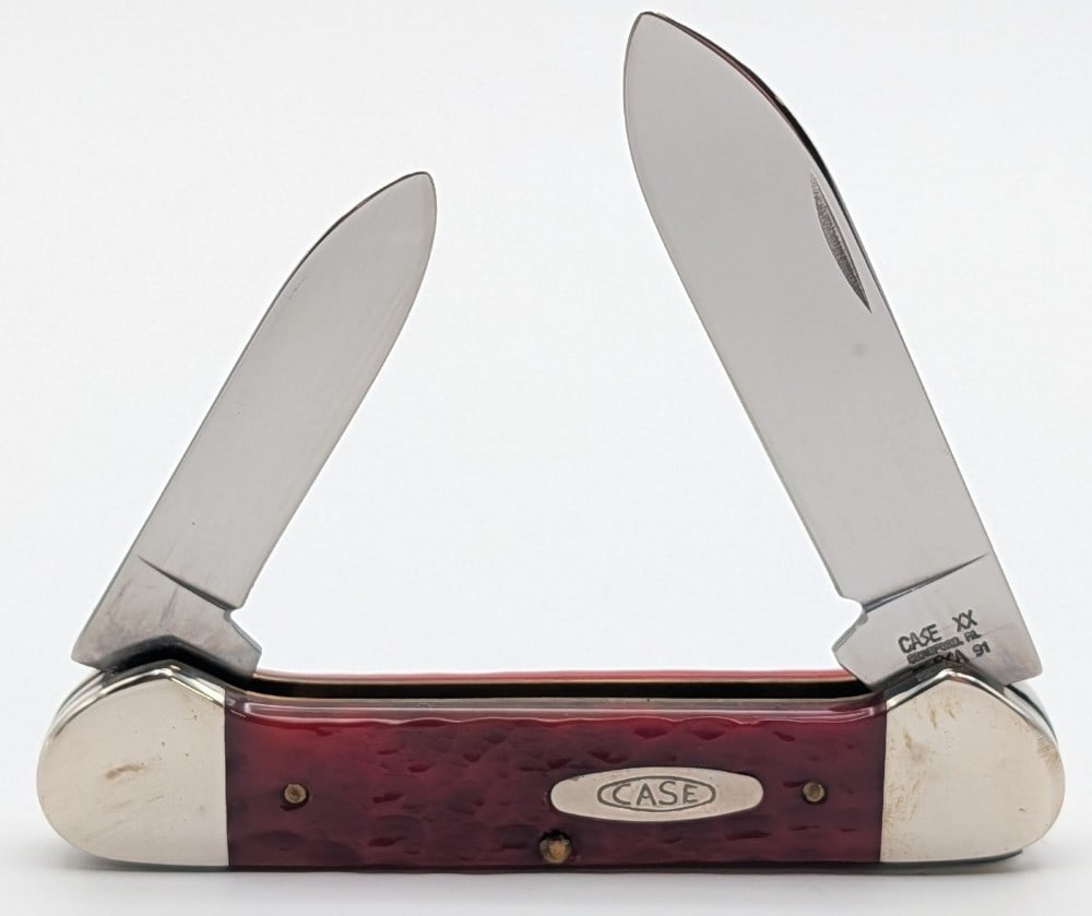 1991 Case XX Dark Red Bone Canoe Knife 62131: Knife is in very nice condition with light scuffs on the bolsters from handling. Overall measures 3-5/8in when closed.
