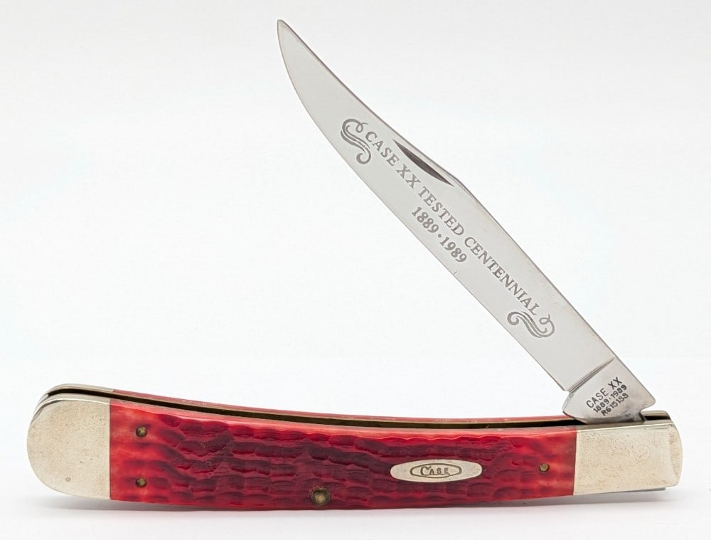 1989 Case XX Centennial Red Bone Large Trapper R6151: Knife is in nice condition with scuffs and tarnishing on the bolsters from handling. Overall measures 5-1/4in when closed.