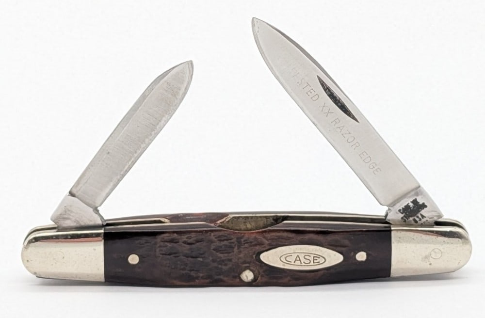 1976 Case XX Jigged Bone Eisenhower 06263: Knife is in nice condition with light scuffs on the blade, and light scuffs and tarnishing on the bolsters from handling and age. Overall measures 3-1/8in when closed.