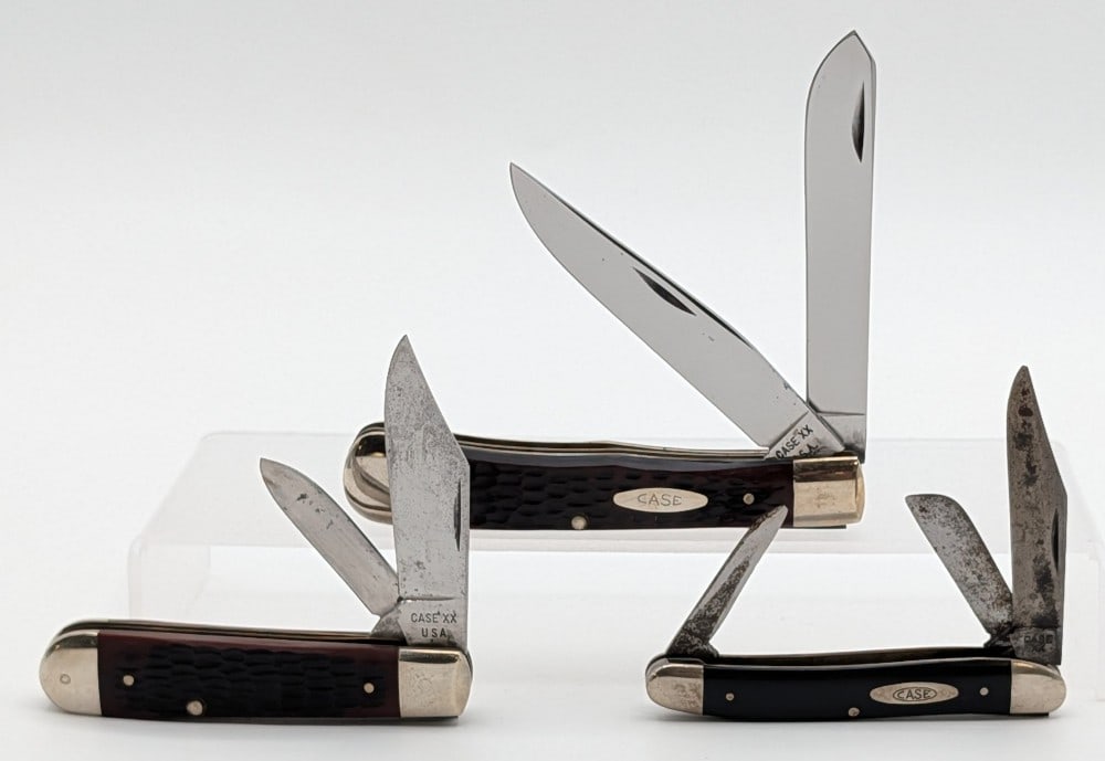 1940-64, 74, & 79 Case XX Delrin & Slick Black Folding Knives: Includes a Trapper 6254, Jack Knife 6235 1/2, and Medium Stockman 087. Knives are in various conditions with different amounts of scratches and wear from use and handling. Largest overall measures 4-1