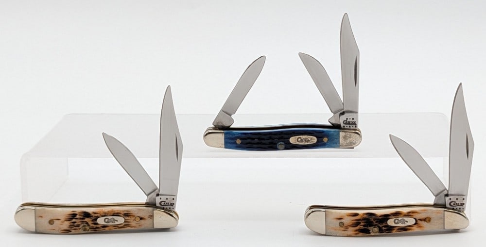 2002 & 13 Case XX Burnt & Blue Bone Peanuts & Small Stockman: Knives are in very nice condition with light scuffs and tarnishing on the bolsters from handling. Largest overall measures 2-3/4in when closed.
