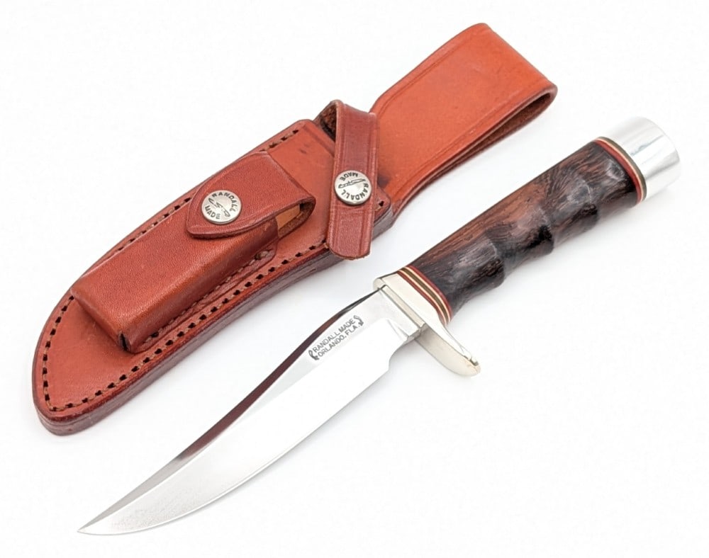 Randall Model 3 5in Finger Groove Desert Ironwood Hunter w/ Sheath: Features a named blade Chet D. Traylor, a finger groove Mexican desert ironwood handle, and a duralumin butt cap. Knife is in nice condition with some carbon spots on the blade, and light scratches an