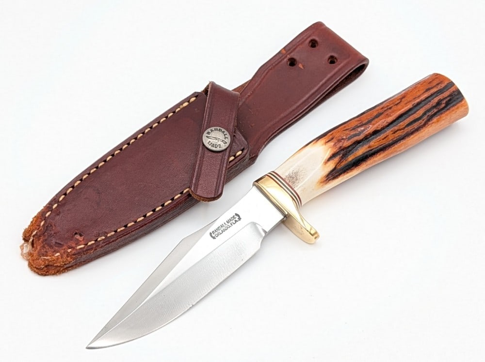 Randall Model 8 Stag Trout & Bird Knife w/ Sheath: Features a brass single downturned guard, and a gorgeous stag handle. Knife is in nice condition with some scratches and carbon spots on the blade, and scuffs and tarnishing on the guard from