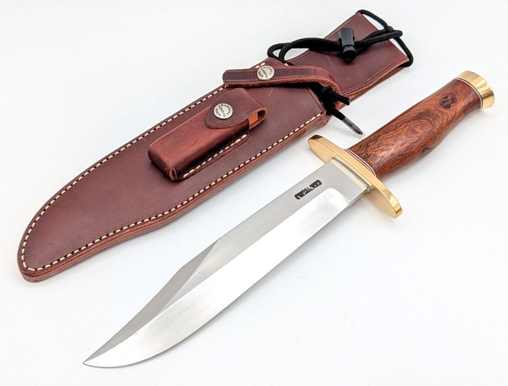 Randall Model 12 9in Sportsman Bowie Knife w/ Sheath: Features a brass double upturned oblong guard, a Mexican desert ironwood handle, and a brass butt cap. Knife is in very nice condition with some light carbon spots on the blade, and light scuffs on th