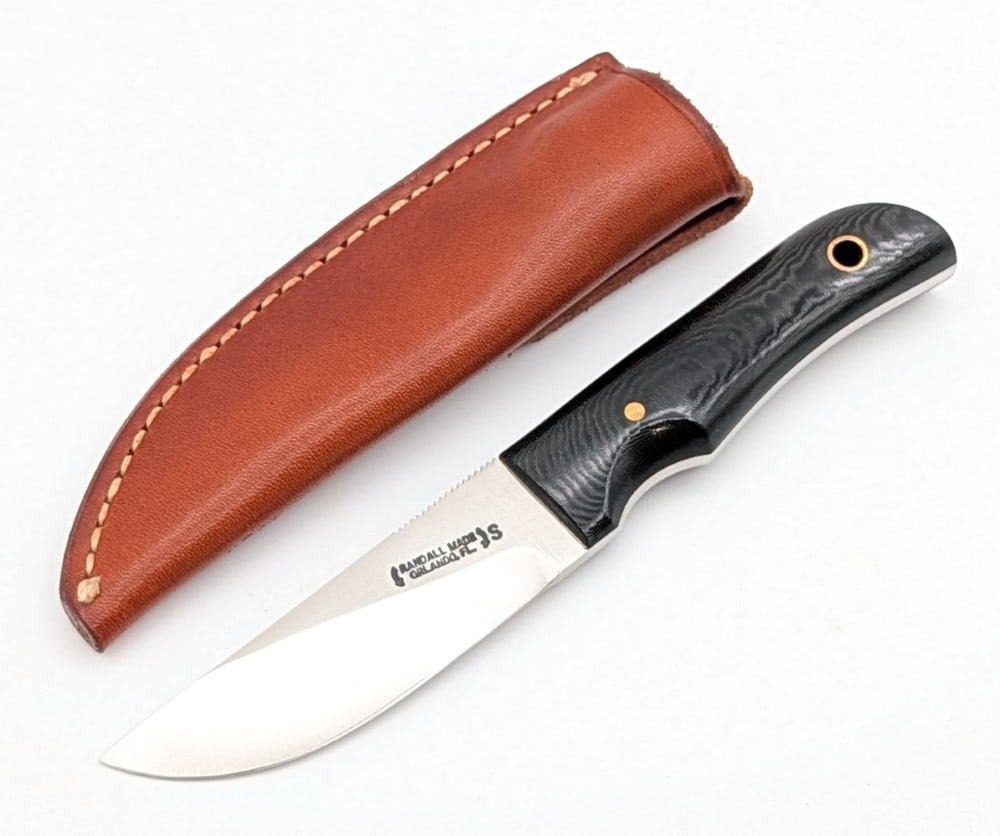 Randall Model 10 3in Black Micarta Utility Knife w/ Sheath: Features a stainless steel blade with thumb notches, a full tang handle construction, black micarta handle scales, and a lanyard hole. Knife is in like new condition. Blade length measures 3in and ove