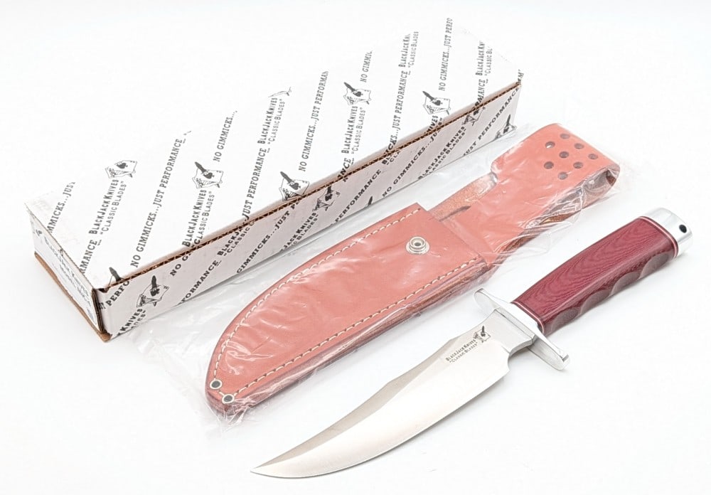 1st Run Blackjack Knives Model MK-4 Red Linen Micarta Classic Skinner w/ Sheath & Box: Features a satin finish blade, a polished steel double guard, a finger groove red linen micarta handle, a polished steel butt cap with a lanyard hole, and a nut pommel. Knife is in new condition. Blad