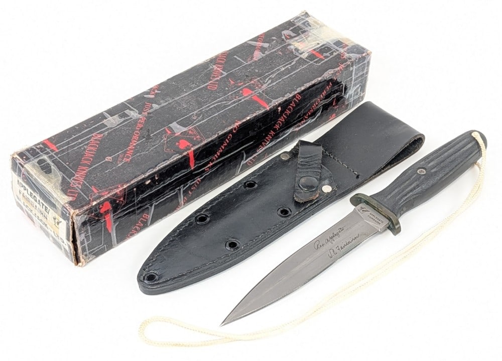 Blackjack Knives Applegate-Fairbairn Fighting Dagger w/ Sheath & Box: Features a bead blast finish double edged blade, a brass double guard, and a molded plastic handle. Knife is in nice condition with some light scuffs on the blade, and nice tarnishing on the guard wit