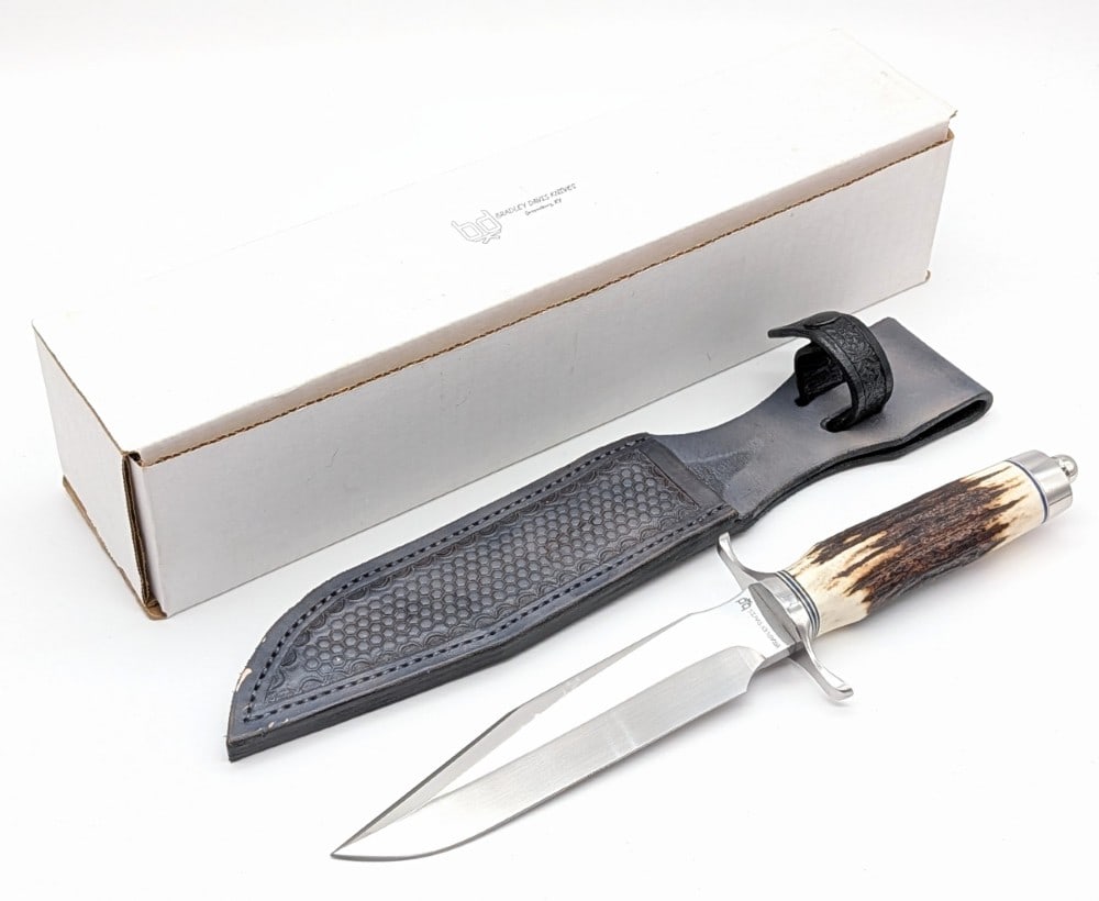 2025 Bradley Davis Custom Randall Model 1 Fighter w/ Sheath & Box: Features a Randall model 1 style mirror polished blade, a stainless steel double downturned guard, a sambar stag handle, and a stainless steel butt cap with a nut pommel. Comes in the original box wit