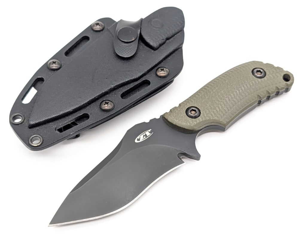 Zero Tolerance Model 0121 Strider Fixed Blade Knife w/ Sheath: Features a black finish drop point blade with thumb notches, a full tang handle, and ranger green G-10? handle scales. Knife is in very nice condition with minimal wear from handling. Blade length mea