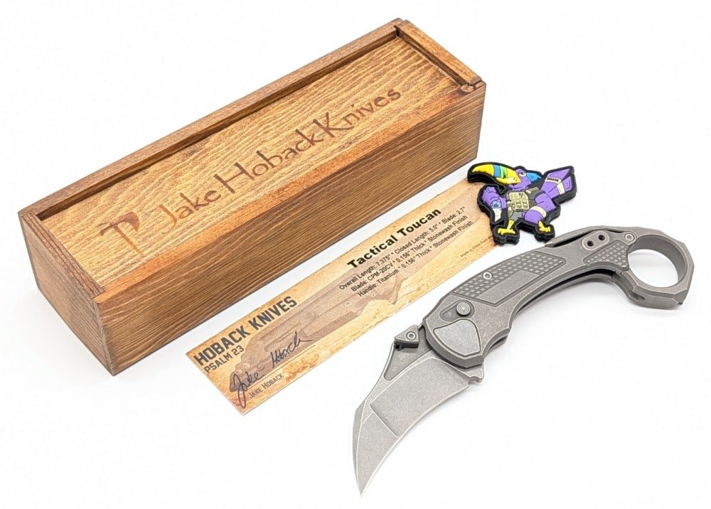 Jake Hoback Tactical Toucan Titanium Karambit Folding Knife w/ Box: Features a stonewash finish CPM-20CV blade, a stonewash finish titanium handle, and a karambit speed ring with a glass breaker bead. The speed ring is removeable turning this knife into a typical