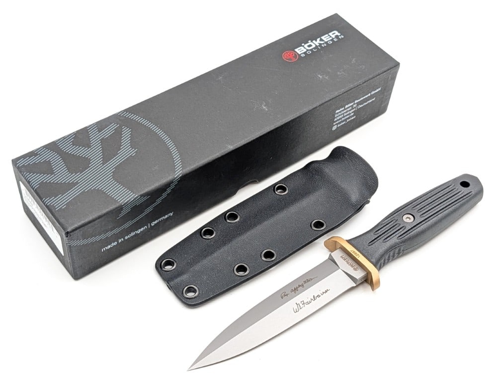 NIB Boker Plus Applegate-Fairbairn Combat II Boot Dagger w/ Sheath: Features a bead blast finish blade, a brass double guard, and a reinforced delrin handle. Knife is in new condition. Blade length measures 4-5/8in and overall 8-7/8in.