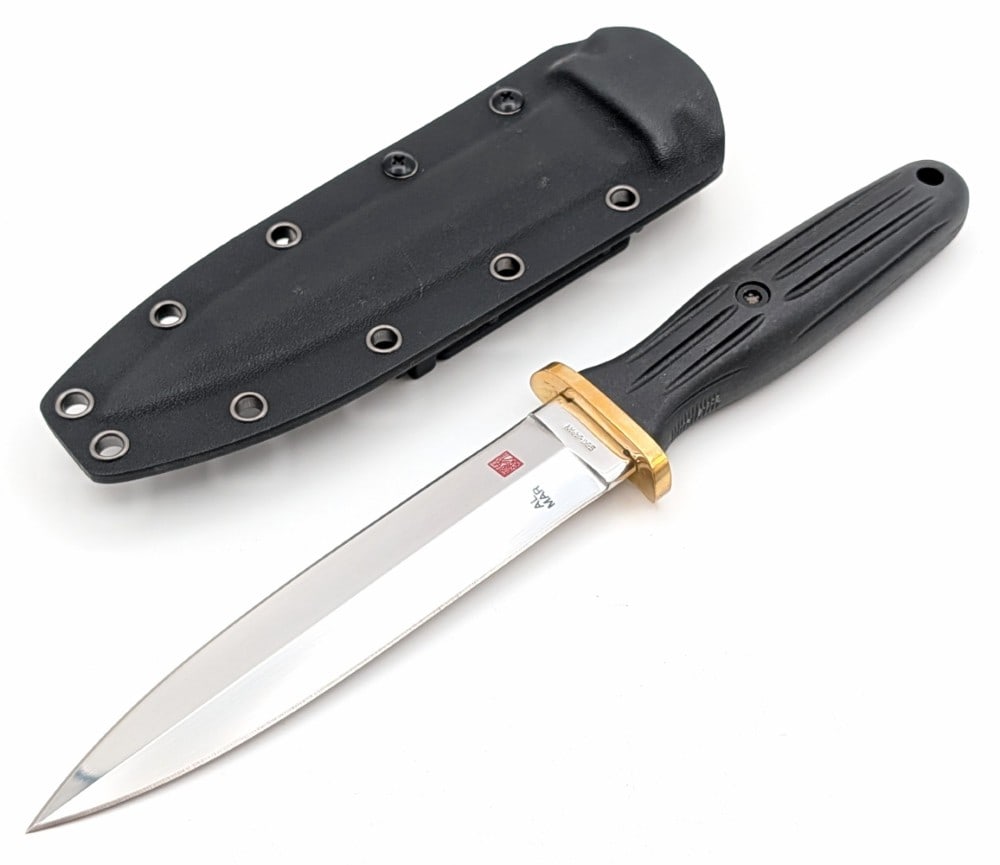 Al Mar Applegate Fairbairn Presentation Fighting Knife w/ Sheath: Features a mirror polished blade, a polished brass guard, and a molded plastic handle. Knife is in like new condition with minimal wear from handling. Blade length measures 6-1/4in and overall
