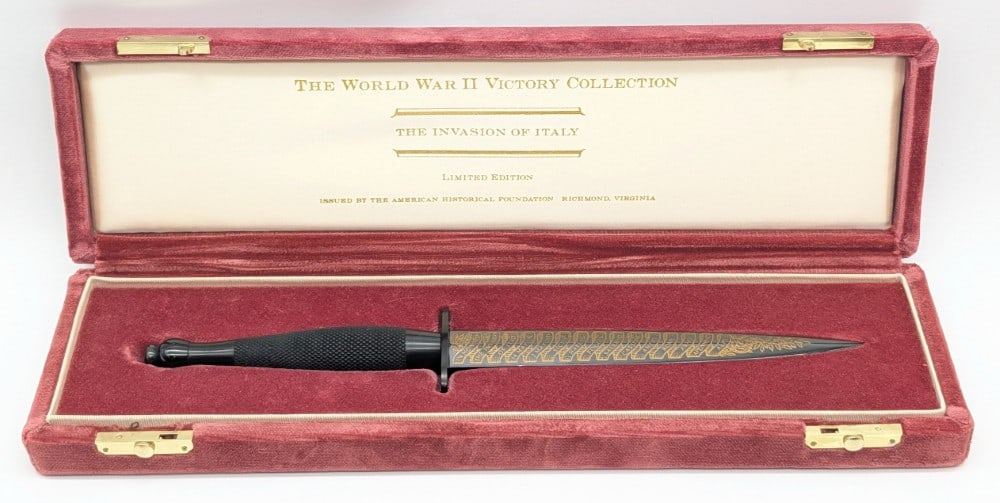 Ltd American Historical Society WWII Italian Invasion Commemorative Sikes Dagger w/ Case: Knife is numbered 364 of 2500 and comes in the display case with the COA. Features a polished blued finish blade with different city names in Italy, a black finish guard and pommel, and a knurled meta