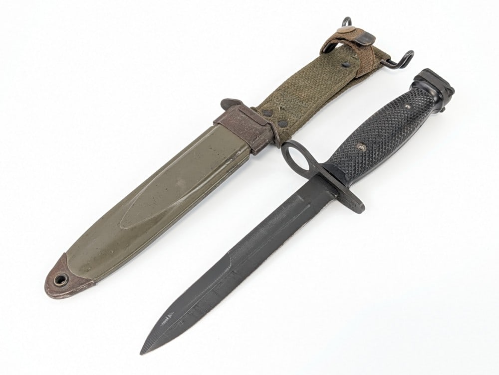 Vietnam Era U.S. Conetta M7 Bayonet w/ Scabbard: Bayonet is in nice condition with light sharpening scratches and finish wear on the blade, and other scuffs from use and handling. Blade length measures 6-5/8in and overall 11-3/4in.