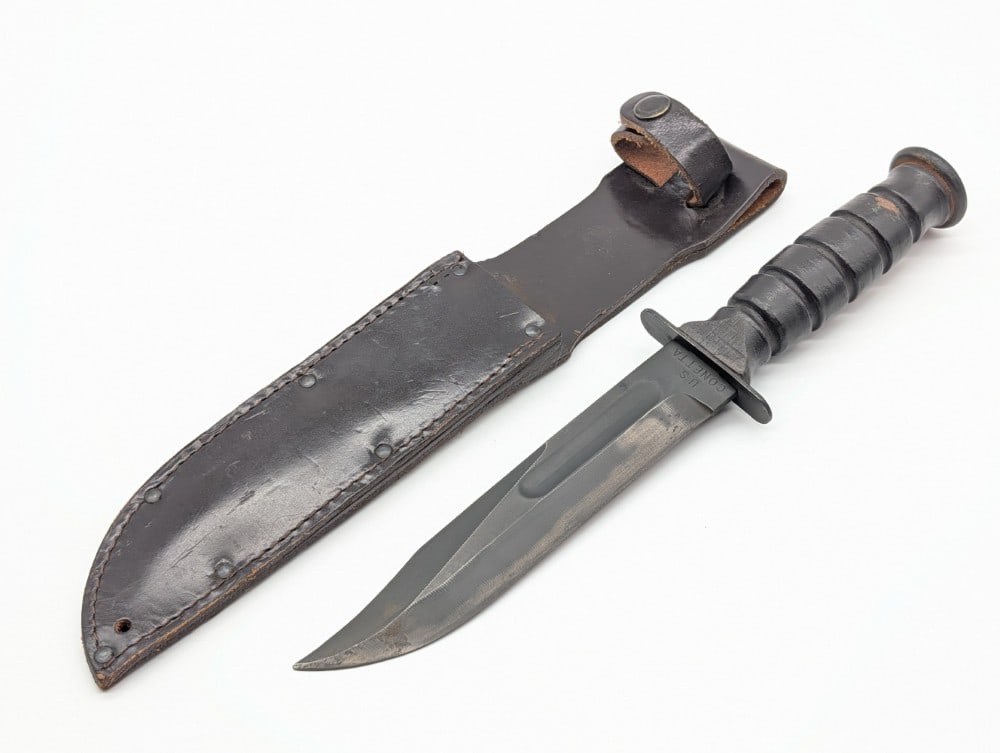 Vietnam Era U.S. Conetta Fighting Knife w/ Sheath: Knife is in very nice condition with light finish wear and some tarnishing on the blade, and scuffs on the leather handle. Blade length measures 7in and overall 12in.