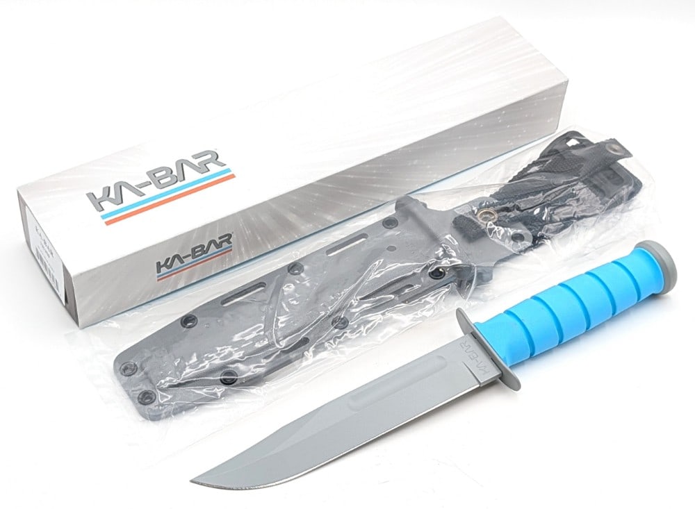 NIB Ka-Bar Space Force Fighting Knife w/ Sheath: Features a gray powder coated finish blade and hardware, and a blue Kraton G handle. Knife is in new condition. Blade length measures 7in and overall 12in.